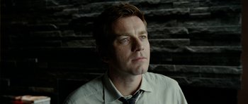 Movie still from “The Ghost Writer” (2010), directed by Roman Polanski – A person wearing a shirt and a tie; Close Up shot, Low angle