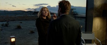 Movie still from “The Ghost Writer” (2010), directed by Roman Polanski – A woman and a man standing next to each other in the desert; Close Up shot, Over the shoulder angle