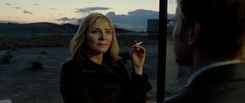 Movie still from “The Ghost Writer” (2010), directed by Roman Polanski – A woman is holding a cigarette in her hand; Close Up shot, Over the shoulder angle