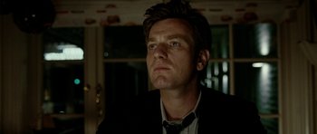 Movie still from “The Ghost Writer” (2010), directed by Roman Polanski – A person wearing a suit and tie; Close Up shot, Low angle