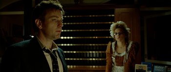 Movie still from “The Ghost Writer” (2010), directed by Roman Polanski – A man and a woman standing next to each other; Medium shot, Over the shoulder angle