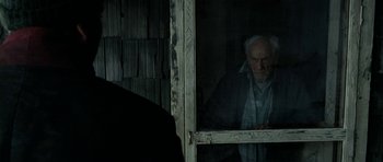 Movie still from “The Ghost Writer” (2010), directed by Roman Polanski – An old man looking out of a window; Medium shot, Over the shoulder angle