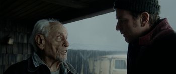 Movie still from “The Ghost Writer” (2010), directed by Roman Polanski – A man talking to another man in front of a truck; Close Up shot, Over the shoulder angle