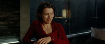 Movie still from “The Ghost Writer” (2010), directed by Roman Polanski – A woman in a red shirt is sitting down; Close Up shot, Over the shoulder angle