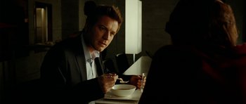 Movie still from “The Ghost Writer” (2010), directed by Roman Polanski – A man sitting at a table with a bowl of soup; Close Up shot, Over the shoulder angle