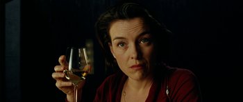 Movie still from “The Ghost Writer” (2010), directed by Roman Polanski – A woman holding a glass of wine in her hand; Close Up shot, Low angle