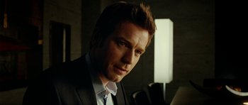 Movie still from “The Ghost Writer” (2010), directed by Roman Polanski – A person wearing a suit and tie; Close Up shot, Over the shoulder angle