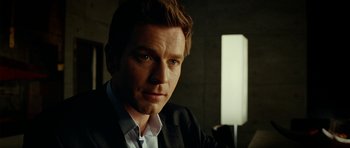 Movie still from “The Ghost Writer” (2010), directed by Roman Polanski – A person wearing a suit and tie; Close Up shot, Over the shoulder angle