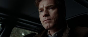 Movie still from “The Ghost Writer” (2010), directed by Roman Polanski – A person in a car looking at the camera; Close Up shot, Low angle
