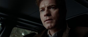 Movie still from “The Ghost Writer” (2010), directed by Roman Polanski – A person in a car looking at the camera; Close Up shot, Low angle