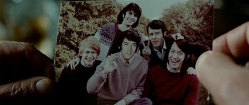 Movie still from “The Ghost Writer” (2010), directed by Roman Polanski – A group of young people posing for a picture; Medium shot, High angle