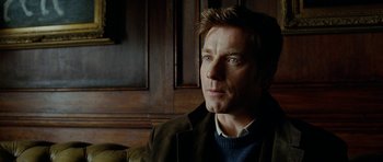 Movie still from “The Ghost Writer” (2010), directed by Roman Polanski – A person sitting in a room; Close Up shot, Over the shoulder angle