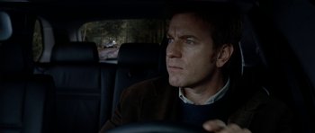Movie still from “The Ghost Writer” (2010), directed by Roman Polanski – A person in a car; Close Up shot, Over the shoulder angle