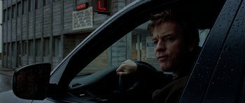 Movie still from “The Ghost Writer” (2010), directed by Roman Polanski – A man sitting in the drivers seat of a car; Close Up shot, Over the shoulder angle
