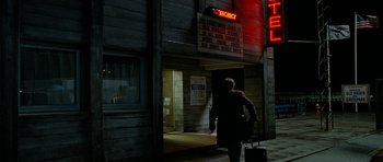 Movie still from “The Ghost Writer” (2010), directed by Roman Polanski – A person walking down a street with a suitcase; Wide shot, High angle