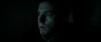 Movie still from “The Ghost Writer” (2010), directed by Roman Polanski – A person looking at the camera; Close Up shot, Low angle