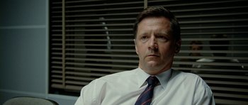 Movie still from “The Ghost Writer” (2010), directed by Roman Polanski – A person wearing a shirt and tie; Close Up shot, Low angle