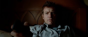 Movie still from “The Ghost Writer” (2010), directed by Roman Polanski – A person sitting on a couch; Close Up shot, Over the shoulder angle