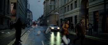 Movie still from “The Ghost Writer” (2010), directed by Roman Polanski – A woman is walking down the street on a rainy day; Extreme Wide shot, High angle