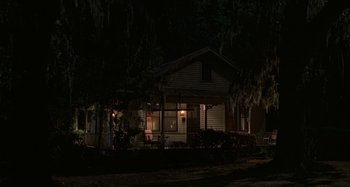 Movie still from “The Gift” (2000), directed by Sam Raimi – A house that is lit up at night time; Extreme Wide shot, High angle