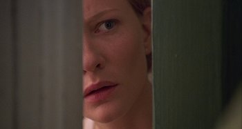 Movie still from “The Gift” (2000), directed by Sam Raimi – A person's face in a bathroom mirror; Extreme Close Up shot, Over the shoulder angle