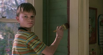 Movie still from “The Gift” (2000), directed by Sam Raimi – A young boy is painting a wall with a paintbrush; Close Up shot, Low angle