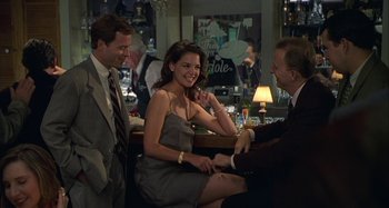 Movie still from “The Gift” (2000), directed by Sam Raimi – A man and a woman sitting at a table with another man; Medium shot, Over the shoulder angle