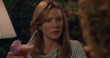 Movie still from “The Gift” (2000), directed by Sam Raimi – A person holding a glass of water; Close Up shot, Over the shoulder angle