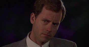 Movie still from “The Gift” (2000), directed by Sam Raimi – A person wearing a suit and tie; Close Up shot, Over the shoulder angle