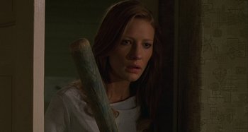 Movie still from “The Gift” (2000), directed by Sam Raimi – A woman holding a baseball bat in a dark room; Close Up shot, High angle