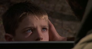 Movie still from “The Gift” (2000), directed by Sam Raimi – A young boy with blue eyes looking at a computer screen; Close Up shot, Over the shoulder angle