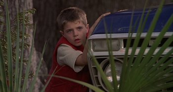 Movie still from “The Gift” (2000), directed by Sam Raimi – A young boy leaning on the hood of a car; Close Up shot, Low angle
