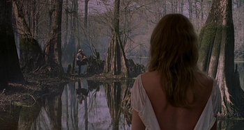 Movie still from “The Gift” (2000), directed by Sam Raimi – A woman standing in front of a body of water; Wide shot, Over the shoulder angle