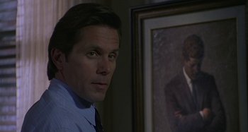 Movie still from “The Gift” (2000), directed by Sam Raimi – A man standing next to a painting of himself; Close Up shot, Over the shoulder angle