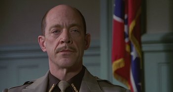 Movie still from “The Gift” (2000), directed by Sam Raimi – A person wearing a suit and tie; Close Up shot, Low angle