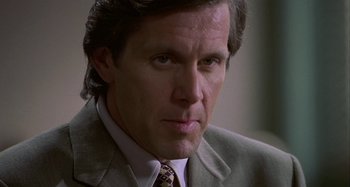 Movie still from “The Gift” (2000), directed by Sam Raimi – A person wearing a suit and tie; Close Up shot, Low angle