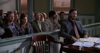 Movie still from “The Gift” (2000), directed by Sam Raimi – A group of people sitting in a courtroom; Medium shot, Low angle