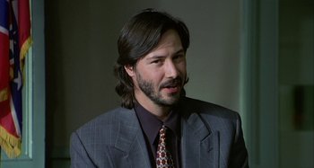 Movie still from “The Gift” (2000), directed by Sam Raimi – A person wearing a suit and tie; Close Up shot, Low angle