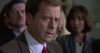 Movie still from “The Gift” (2000), directed by Sam Raimi – A person wearing a suit and a tie; Close Up shot, Over the shoulder angle