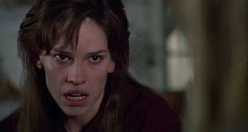 Movie still from “The Gift” (2000), directed by Sam Raimi – A person with long brown hair; Close Up shot, Over the shoulder angle