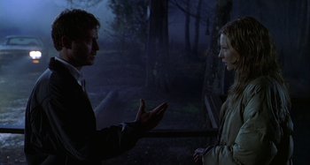 Movie still from “The Gift” (2000), directed by Sam Raimi – A man and a woman talking in the dark; Medium shot, Over the shoulder angle