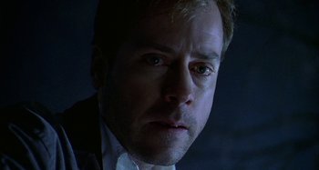 Movie still from “The Gift” (2000), directed by Sam Raimi – A person wearing a suit and tie; Close Up shot, Low angle