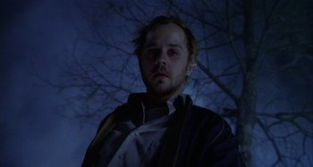 Movie still from “The Gift” (2000), directed by Sam Raimi – A man standing in front of a tree at night; Close Up shot, Low angle