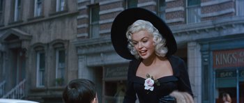 Movie still from “The Girl Can't Help It” (1956), directed by Frank Tashlin – A woman wearing a black dress and a hat; Medium shot, Over the shoulder angle