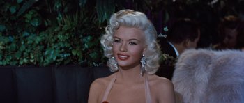 Movie still from “The Girl Can't Help It” (1956), directed by Frank Tashlin – A person wearing a dress; Close Up shot, Over the shoulder angle