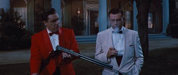 Movie still from “The Girl Can't Help It” (1956), directed by Frank Tashlin – Two men in tuxedos are standing next to each other; Medium shot, Low angle