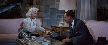 Movie still from “The Girl Can't Help It” (1956), directed by Frank Tashlin – An older couple sitting at a dinner table; Medium shot, Over the shoulder angle