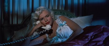 Movie still from “The Girl Can't Help It” (1956), directed by Frank Tashlin – A woman laying on a bed talking on a phone; Close Up shot, High angle