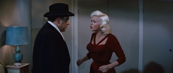 Movie still from “The Girl Can't Help It” (1956), directed by Frank Tashlin – A man and a woman are talking in a room; Medium shot, Over the shoulder angle
