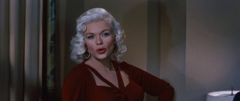 Movie still from “The Girl Can't Help It” (1956), directed by Frank Tashlin – A woman with white hair is posing for a picture; Close Up shot, Over the shoulder angle